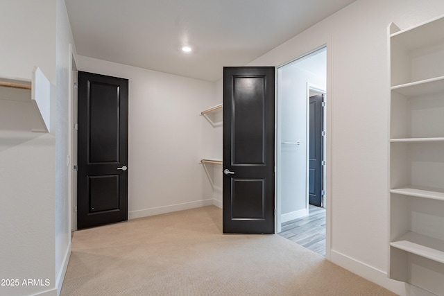 spacious closet featuring carpet