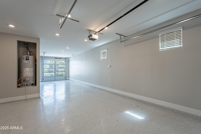 garage featuring water heater, a garage door opener, baseboards, and recessed lighting