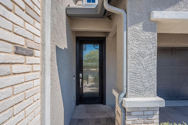 property entrance featuring stucco siding