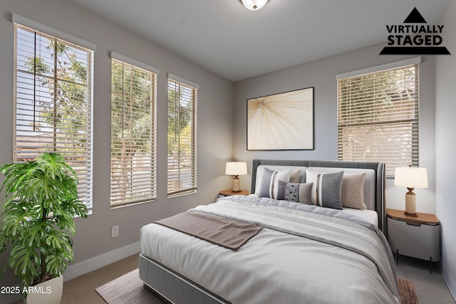 carpeted bedroom featuring baseboards