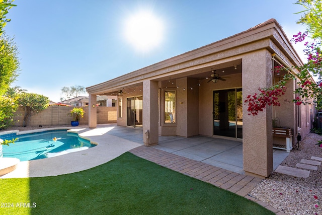 view of swimming pool with ceiling fan and a patio