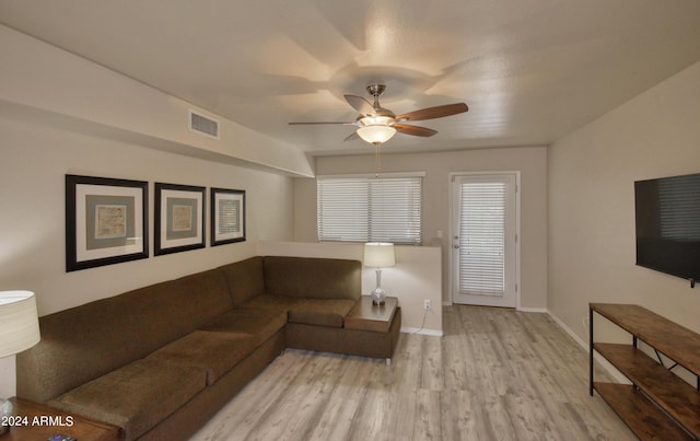 living room with ceiling fan and light hardwood / wood-style flooring