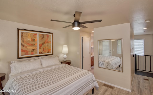 bedroom featuring a textured ceiling, light hardwood / wood-style flooring, and ceiling fan