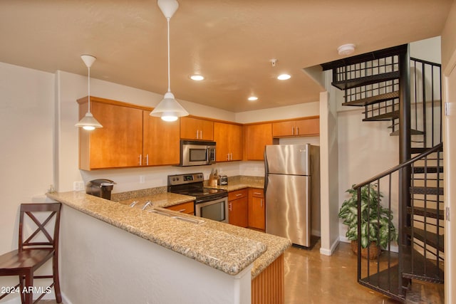 kitchen with light stone counters, decorative light fixtures, a kitchen breakfast bar, kitchen peninsula, and stainless steel appliances