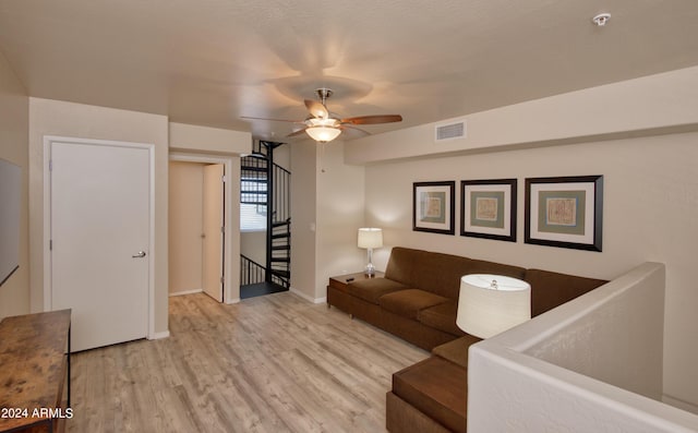 living room with light hardwood / wood-style flooring and ceiling fan