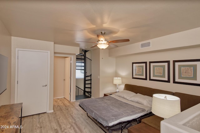 bedroom with ceiling fan and light wood-type flooring