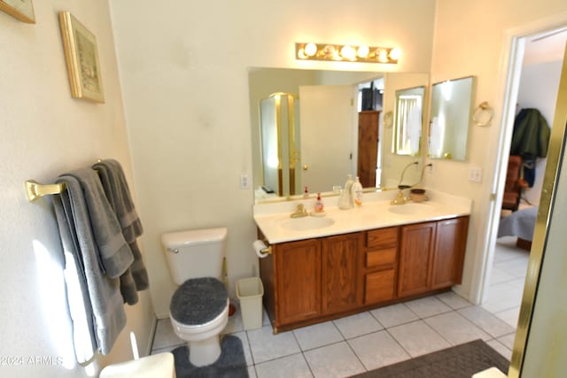 bathroom with tile patterned flooring, vanity, and toilet