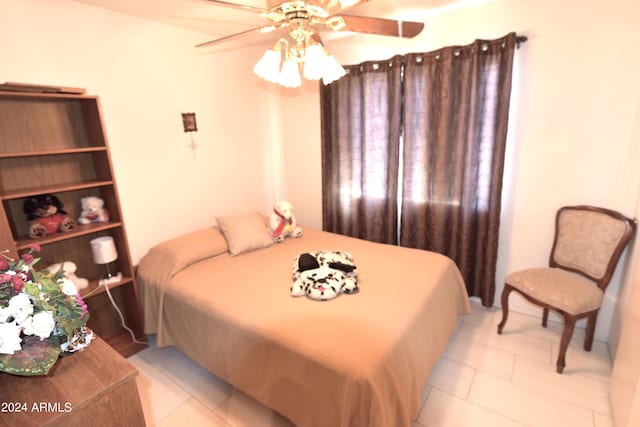 tiled bedroom with ceiling fan