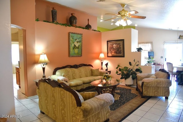 living room featuring light tile patterned flooring, vaulted ceiling, and ceiling fan