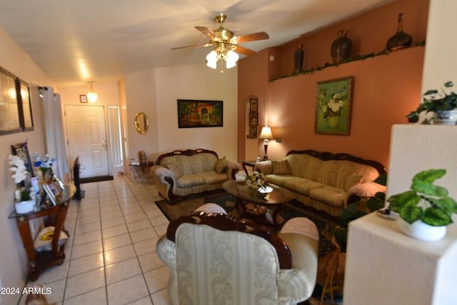 tiled living room featuring ceiling fan and lofted ceiling