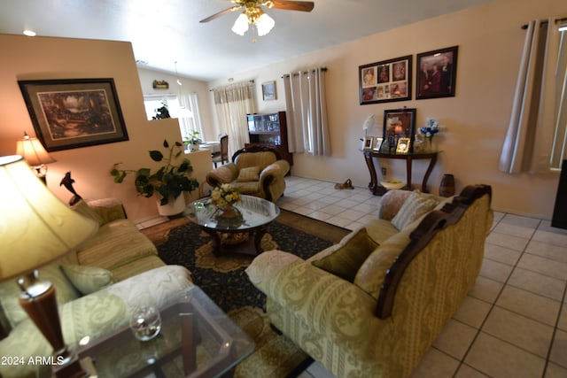 tiled living room featuring lofted ceiling and ceiling fan