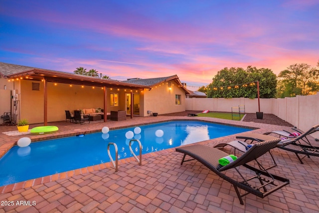 view of swimming pool featuring a fenced in pool, outdoor lounge area, a patio, and a fenced backyard