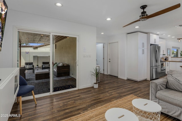 living room featuring baseboards, wood finished floors, a ceiling fan, and recessed lighting