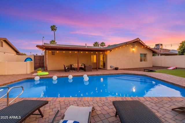 view of pool featuring a fenced backyard, an outdoor hangout area, a fenced in pool, and a patio