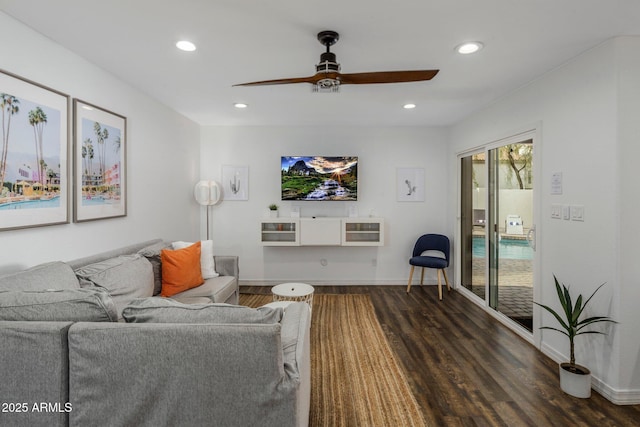 living room with heating unit, baseboards, dark wood-type flooring, and recessed lighting