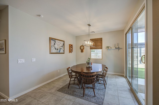 dining space with a chandelier, light tile patterned floors, baseboards, and a wealth of natural light