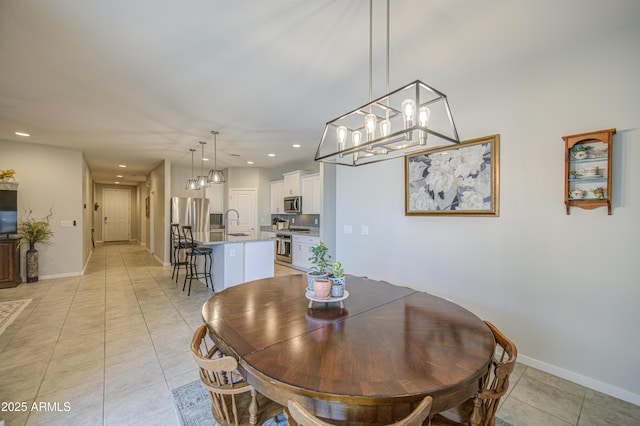 dining room featuring an inviting chandelier, light tile patterned floors, and recessed lighting