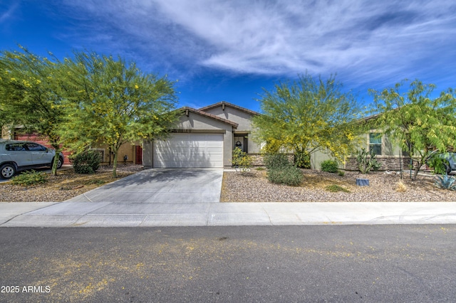 view of front of house featuring an attached garage, driveway, and stucco siding