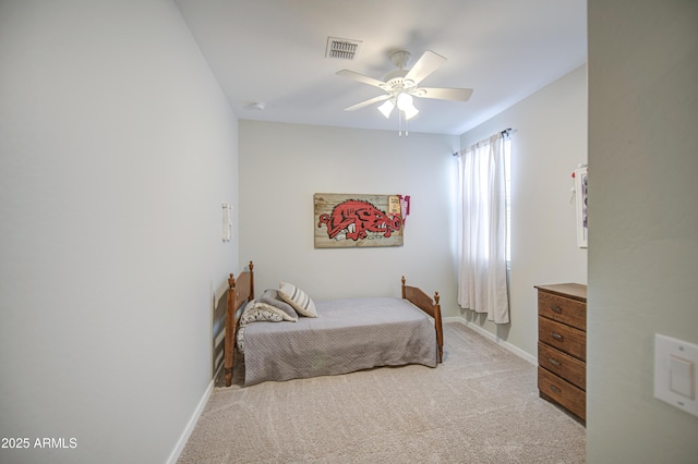 bedroom with visible vents, baseboards, a ceiling fan, and light colored carpet