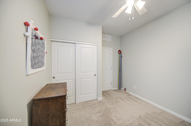 unfurnished bedroom featuring visible vents, baseboards, a closet, ceiling fan, and carpet floors