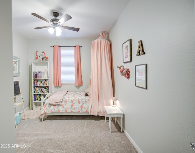 carpeted bedroom featuring baseboards and a ceiling fan