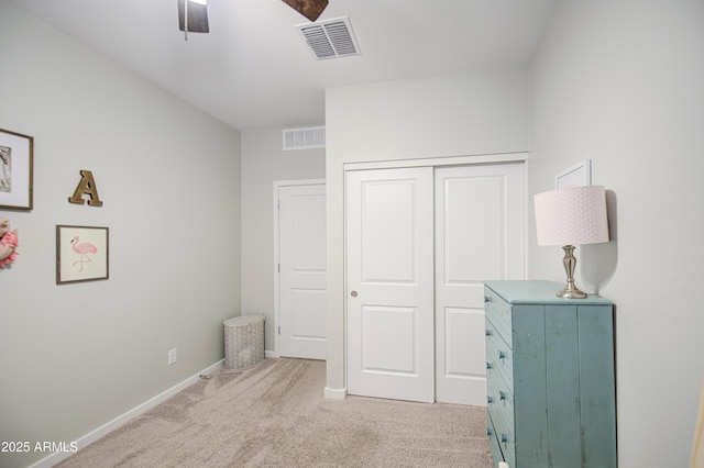 bedroom featuring light carpet, a closet, baseboards, and visible vents