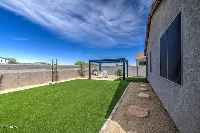 view of yard with a patio area and a fenced backyard