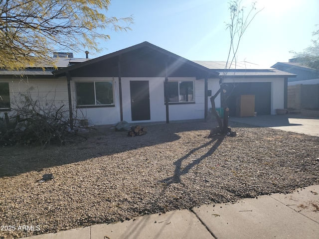 single story home featuring a patio area and concrete driveway