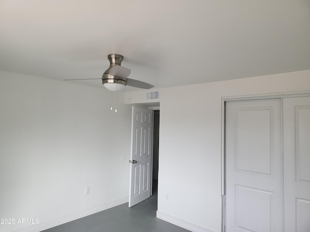 unfurnished bedroom with baseboards, visible vents, ceiling fan, concrete floors, and a closet