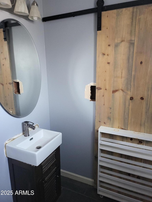 bathroom featuring vanity, baseboards, and tile patterned floors