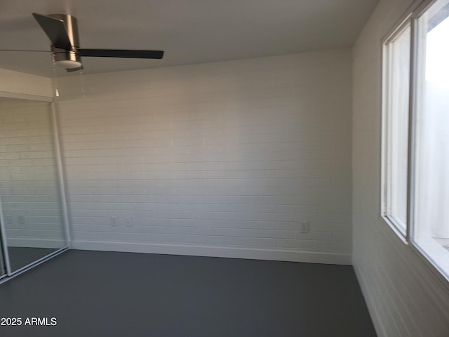 empty room featuring finished concrete floors and a ceiling fan