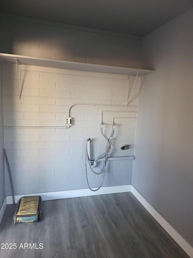 washroom featuring dark wood-style flooring and baseboards