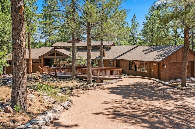 single story home with a deck and a garage