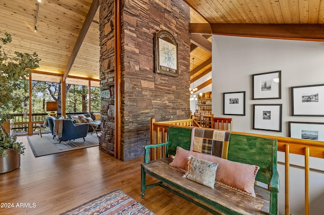 sitting room featuring high vaulted ceiling, beamed ceiling, hardwood / wood-style flooring, and wooden ceiling