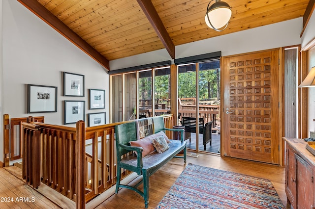 sitting room with wood ceiling, vaulted ceiling with beams, and light hardwood / wood-style flooring