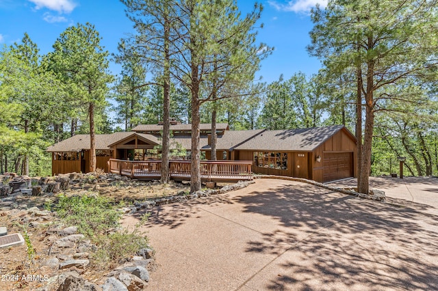 view of front of property featuring a garage and a wooden deck