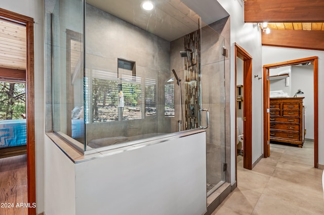 bathroom with lofted ceiling with beams, wood ceiling, and walk in shower