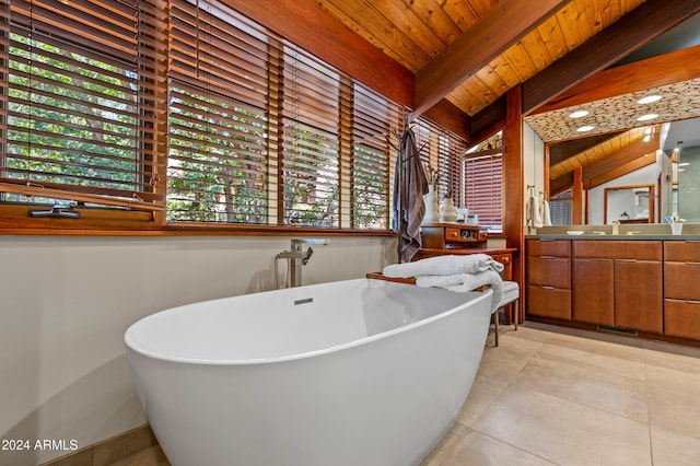 bathroom with a healthy amount of sunlight, a bathing tub, vaulted ceiling with beams, and wood ceiling