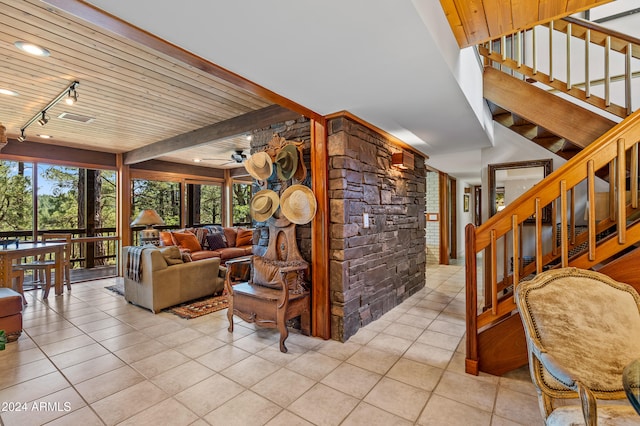 tiled living room with ceiling fan, wood ceiling, and beam ceiling