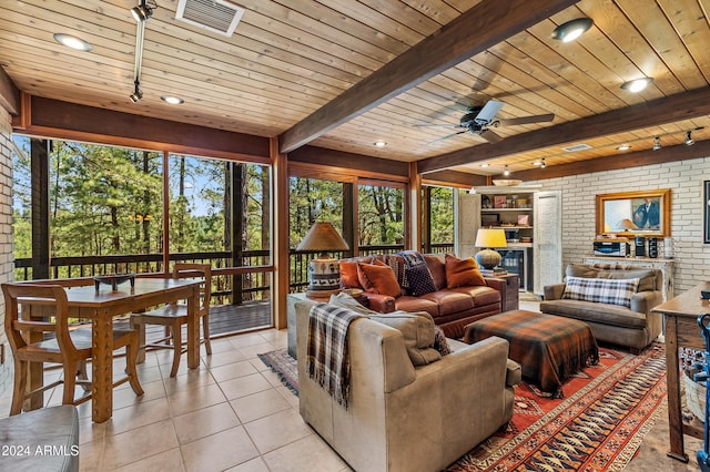 tiled living room with brick wall, beam ceiling, ceiling fan, and wooden ceiling