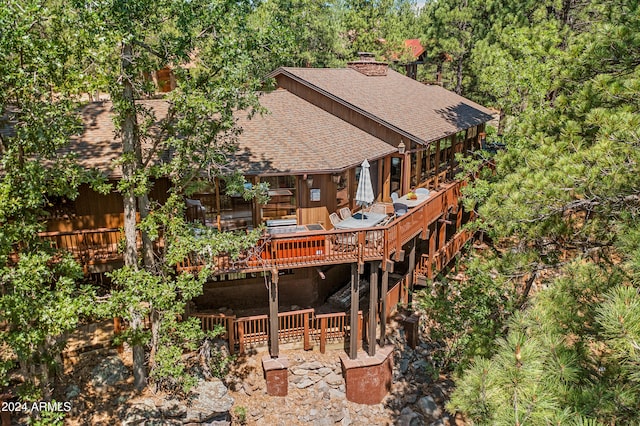 back of property featuring a wooden deck