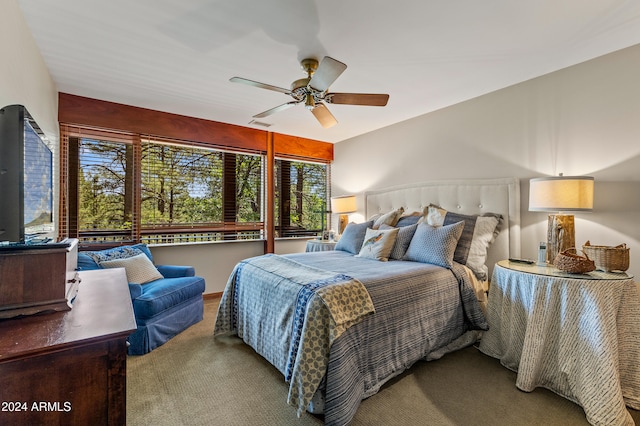 carpeted bedroom with multiple windows and ceiling fan