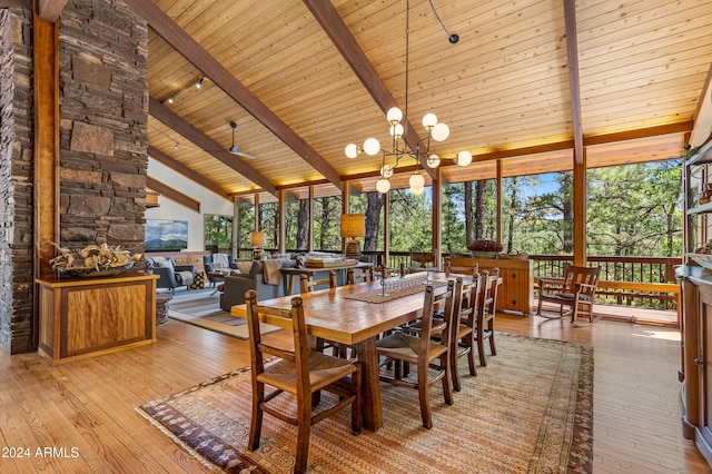 unfurnished dining area with ceiling fan with notable chandelier, wood ceiling, high vaulted ceiling, beamed ceiling, and light wood-type flooring