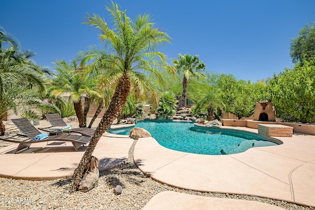 39419 N 7th Ave, Phoenix, AZ 85086 - swimming pool featuring a patio and exterior fireplace