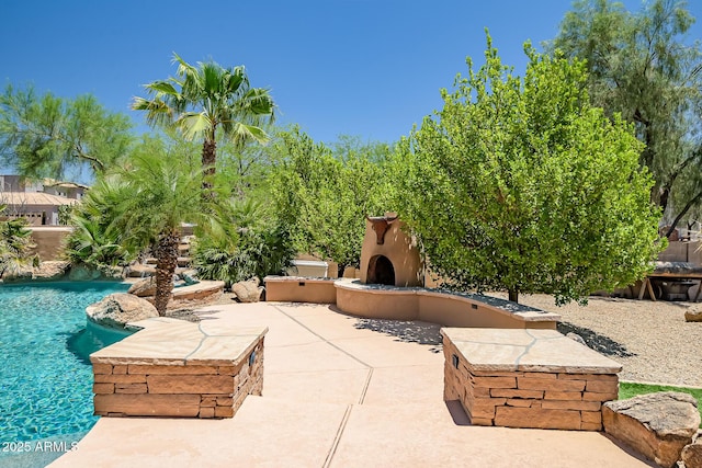 39419 N 7th Ave, Phoenix, AZ 85086 - view of patio featuring exterior fireplace and an outdoor pool