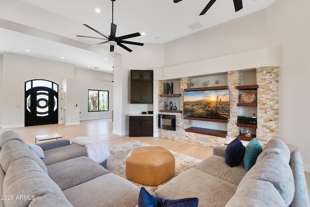39419 N 7th Ave, Phoenix, AZ 85086 - living room featuring a ceiling fan, light wood-type flooring, recessed lighting, baseboards, and a towering ceiling
