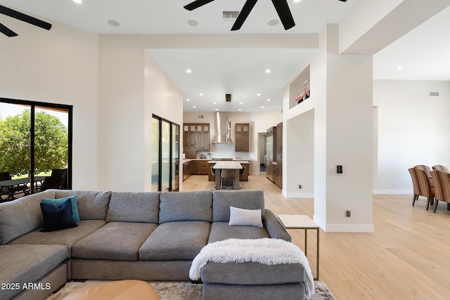 39419 N 7th Ave, Phoenix, AZ 85086 - living room with a ceiling fan, light wood-style flooring, a towering ceiling, recessed lighting, and baseboards