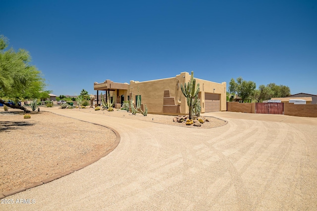 39419 N 7th Ave, Phoenix, AZ 85086 - pueblo revival-style home featuring driveway, an attached garage, and stucco siding