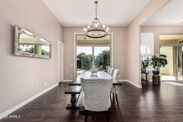 dining space with dark hardwood / wood-style flooring and a notable chandelier