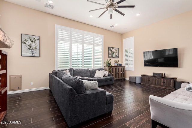 living room featuring dark hardwood / wood-style floors and ceiling fan